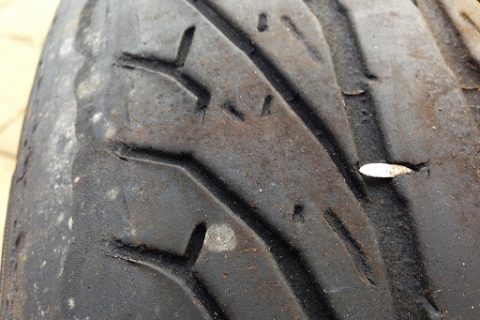 A car tyre with a nail in it during a mobile tyre fitting job in Manchester